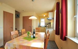 a kitchen with a table with a bottle of wine on it at Stunning Apartment In Fuhlendorf With Lake View in Fuhlendorf