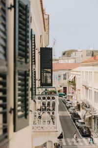Blick auf eine Straße vom Balkon eines Gebäudes in der Unterkunft Mantzarou Suites by Corfu Collection in Ágios Rókkos