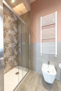 a bathroom with a glass shower and a sink at Room Don Alfonso Luxury in Parma