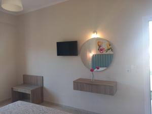 a bedroom with a mirror on the wall and a table at NIKOS DIMAS STUDIOS in Parga