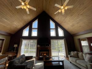 a living room with a ceiling with windows and a fireplace at Ski Boots N Bathing Suits in McHenry +70 photos