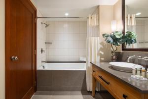 a bathroom with a tub and a sink at Ko Olina Beach Villas B610 in Kapolei
