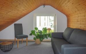 a living room with a couch and a chair and a window at 3 Bedroom Gorgeous Home In Otterndorf in Otterndorf