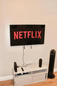 a netflix sign hanging on a wall at Reading's Peaceful Gem in Reading