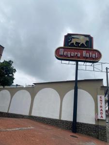 a sign in front of a building at Megara in Rio de Janeiro