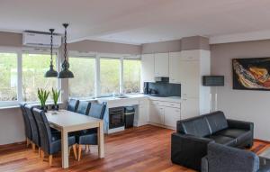 a kitchen and living room with a table and chairs at Awesome Ship In Lith With Kitchen in Lith