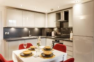 a kitchen with a table with plates and wine glasses at Charming retreat in Bradford in Bradford