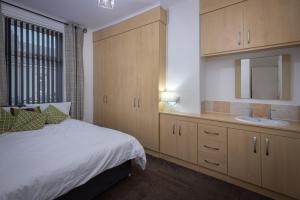 a bedroom with a bed and a sink at Delightful Family Home in Blackpool in Blackpool
