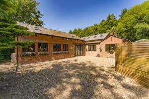 a brick house with a gate in front of it at Victorian Summer Retreat in Liverpool in Knowsley