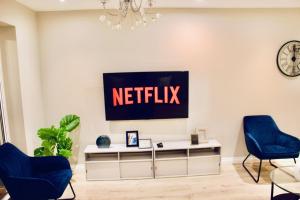 ein Wohnzimmer mit einem Netflix-Schild an der Wand in der Unterkunft A peaceful home with a garden in Reading