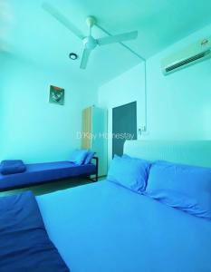 a blue room with two beds and a ceiling fan at Mesahill Studio 2 Fullbed by DKAY in Nilai in Nilai