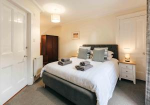 a bedroom with a large bed with towels on it at Kenmore House, Elie in Elie