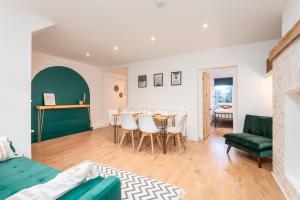 a living room with a green couch and a table at Seafront retreat in Margate in Kent