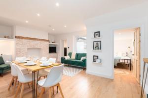 a dining room and living room with a table and chairs at Seafront retreat in Margate in Kent