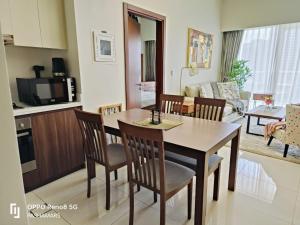 a kitchen and living room with a table and chairs at Reva Residence Luxurious 2 BHK in Dubai
