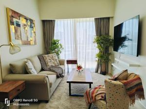 a living room with a couch and a table at Reva Residence Luxurious 2 BHK in Dubai