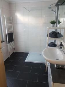 a bathroom with a white sink and a shower at City Ferienhaus in Neheim in Arnsberg +22 photos