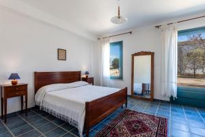 a bedroom with a bed and a large window at Case Malavilla in Santa Croce Camerina