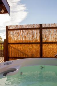 a bath tub in front of a wooden fence at Pheasant's Roost in Foxton