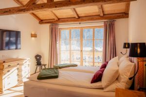 a bedroom with a bed with a large window at Chalet in Fischbachau