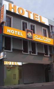 a hotel with a hotel sign on top of it at SohoTown Hotel in Kuala Lumpur
