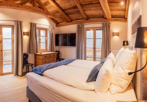 a bedroom with a large bed with wooden ceilings at Chalet in Fischbachau