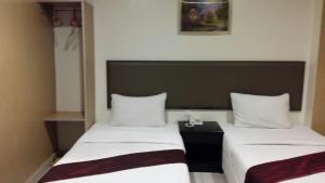 Postel nebo postele na pokoji v ubytování SohoTown Hotel