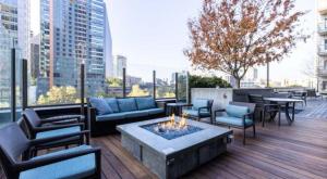 a patio with couches and a fire pit on a building at Via 6 in Seattle