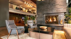 a fireplace in a living room with two chairs and a table at Via 6 in Seattle