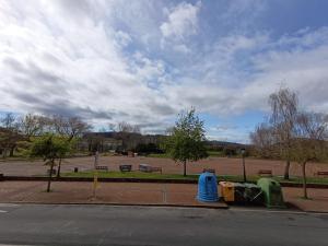 a park with trash cans on the side of a street at LAR DA REVOLTA in Cedeira