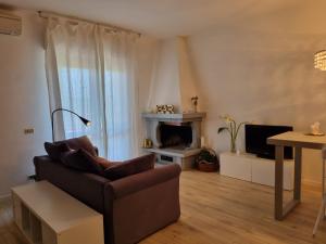 a living room with a couch and a fireplace at A casa di Daniela in Massa Marittima
