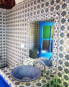 a bathroom with a sink and a mirror at Dar Sandra Bizerte in Bizerte