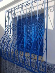 a blue wrought iron railing on a balcony at Dar Sandra Bizerte in Bizerte +3 photos