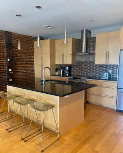 a kitchen with a large island with two chairs at Boston North end Harbor View condo. FREE PARKING in Boston