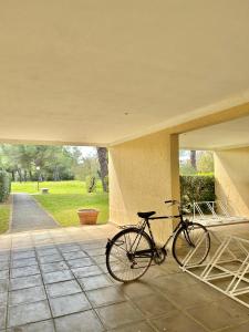 a bike is parked on a porch at Ohana Resort in Marina di Bibbona
