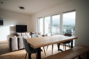 a living room with a wooden table and a couch at Premium Apartments Monterra in Petschnitzen