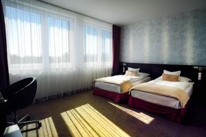 A bed or beds in a room at Hotel Turiec