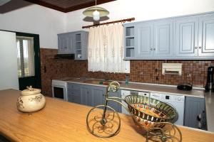 a kitchen with a bike on a wooden table at Dimelia Heaven Farm House in Kranidi in Kranidi