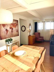 Le Jackrabbit Orford Domaine Cheribourg في Orford: غرفة طعام مع طاولة خشبية وغرفة معيشة