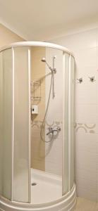 a shower with a glass door in a bathroom at Wellotel Chornomorsk in Chornomorsk +101 photos