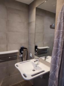 a bathroom with a sink and a mirror at Hotel Nice garni in Ichenhausen