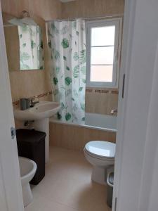 a bathroom with a sink and a toilet and a window at Ático El Paraíso in Cómpeta +21 photos