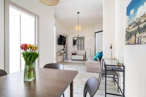 a living room and dining room with a table and chairs at SNT Apartment - City Center in Bergamo