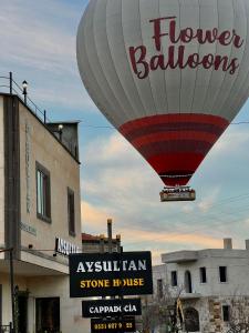 a hot air balloon flying over a store at Aysultan Stone House in Uchisar