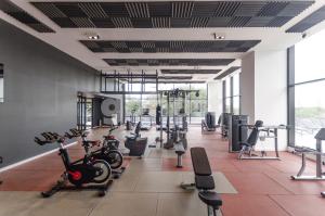 a gym with treadmills and exercise bikes at Luminous Two-bedroom Apartment In Trinidad in Asunción