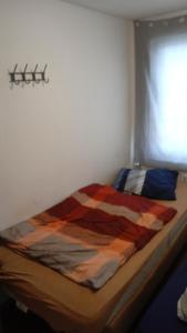 Una cama con una manta encima en una habitación en Dreiseithof bei Luckenwalde, en Schönefeld