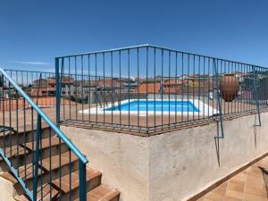 a metal cage around a swimming pool on a building at Casa Rural la Vertedera 2 in Villar de Ciervo