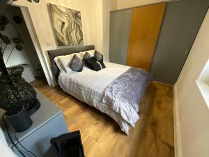 a bedroom with a bed with pillows on it at Badgers Rest with free parking in Apperley Bridge