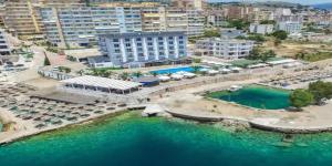 an aerial view of a city with a body of water at SHANO'S Apartment - Free Parking in Sarandë