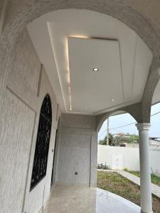 a building with a vaulted ceiling with a large window at Luxueuse cité in Bodjo